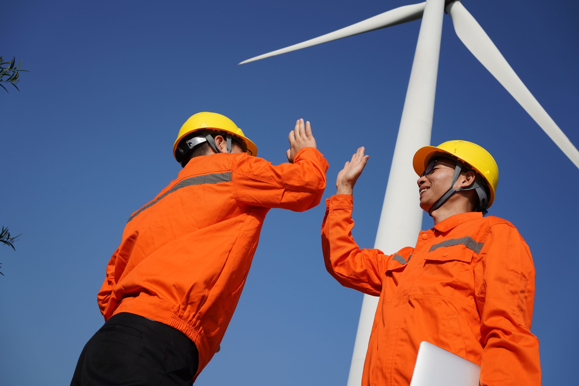 Two asian engineers working together on wind turbine