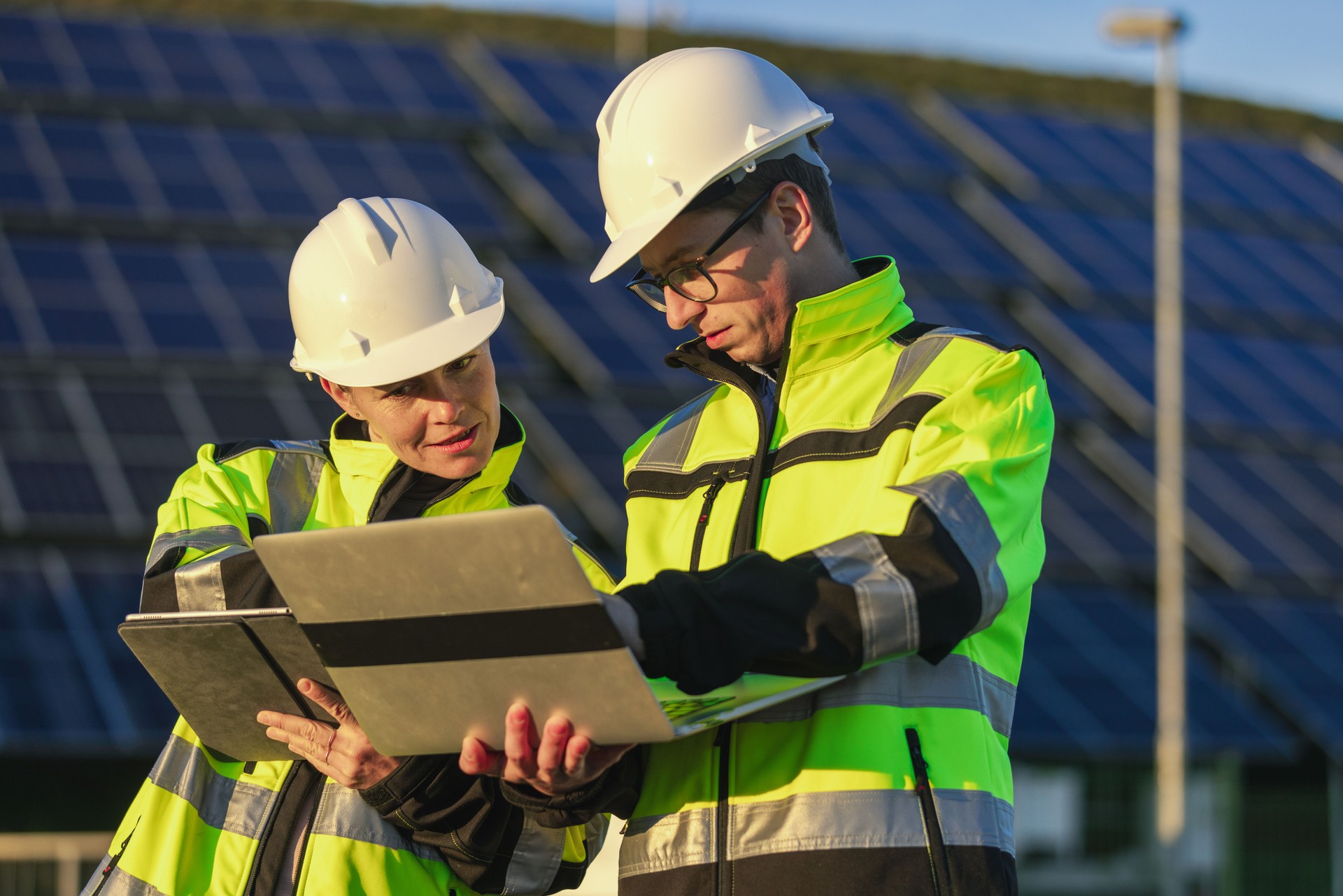 Two engineers discussing operation of solar power station