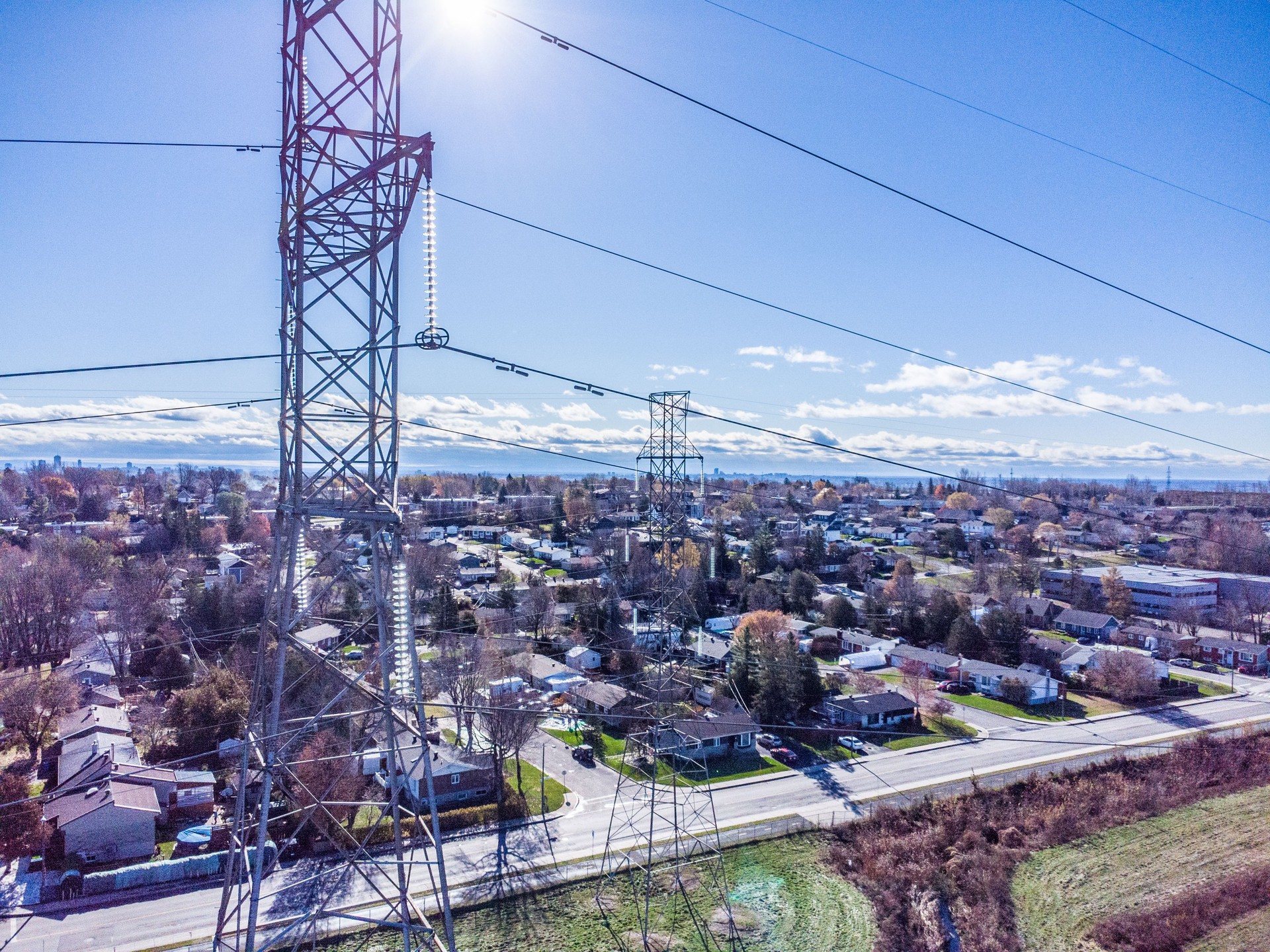 Aerial view of electric pylons in residential area